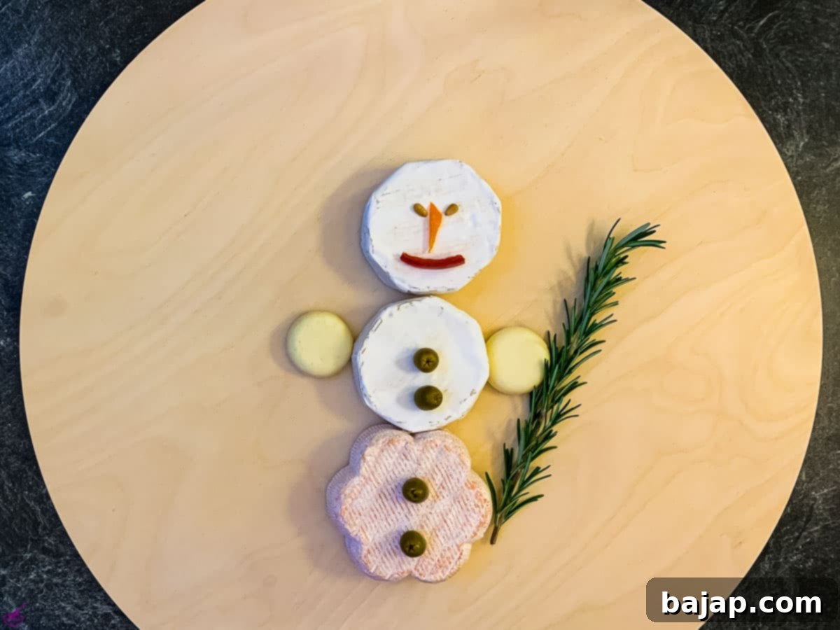 green olives and peppers pieces are nose and mouth from the snowman. Pine nuts the eyes.