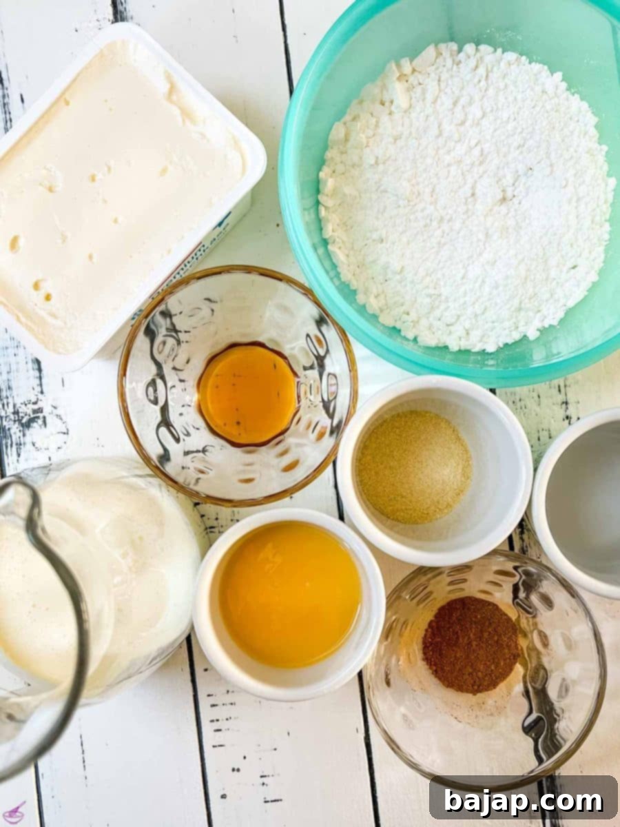 Ingredients for the Christmas cheesecake filling including cream cheese, powdered sugar, vanilla, and eggnog