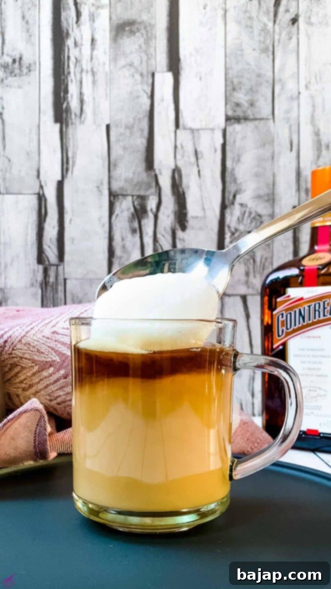 Add a spoonful of frothed milk foam on top of the coffee.