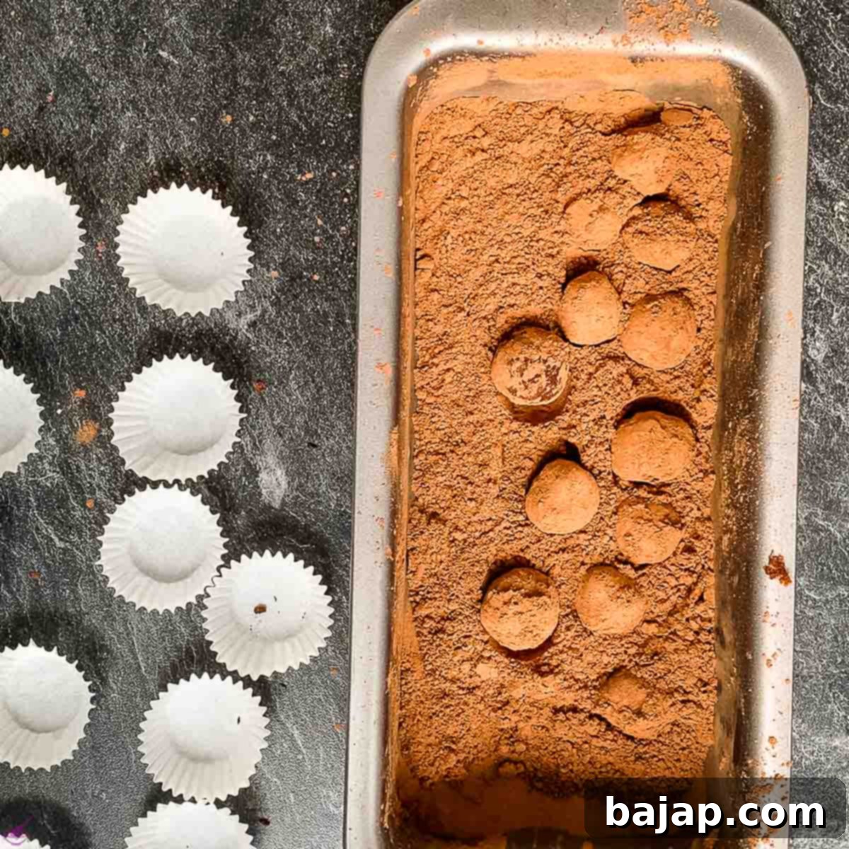 Rolling the Biscoff truffles in cacao powder and placing them into chocolate paper cups.