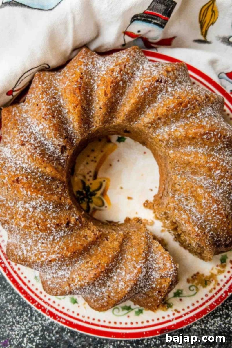 A chestnut bundt cake ready to be served, dusted with powdered sugar, showcasing its rich flavor and moistness.