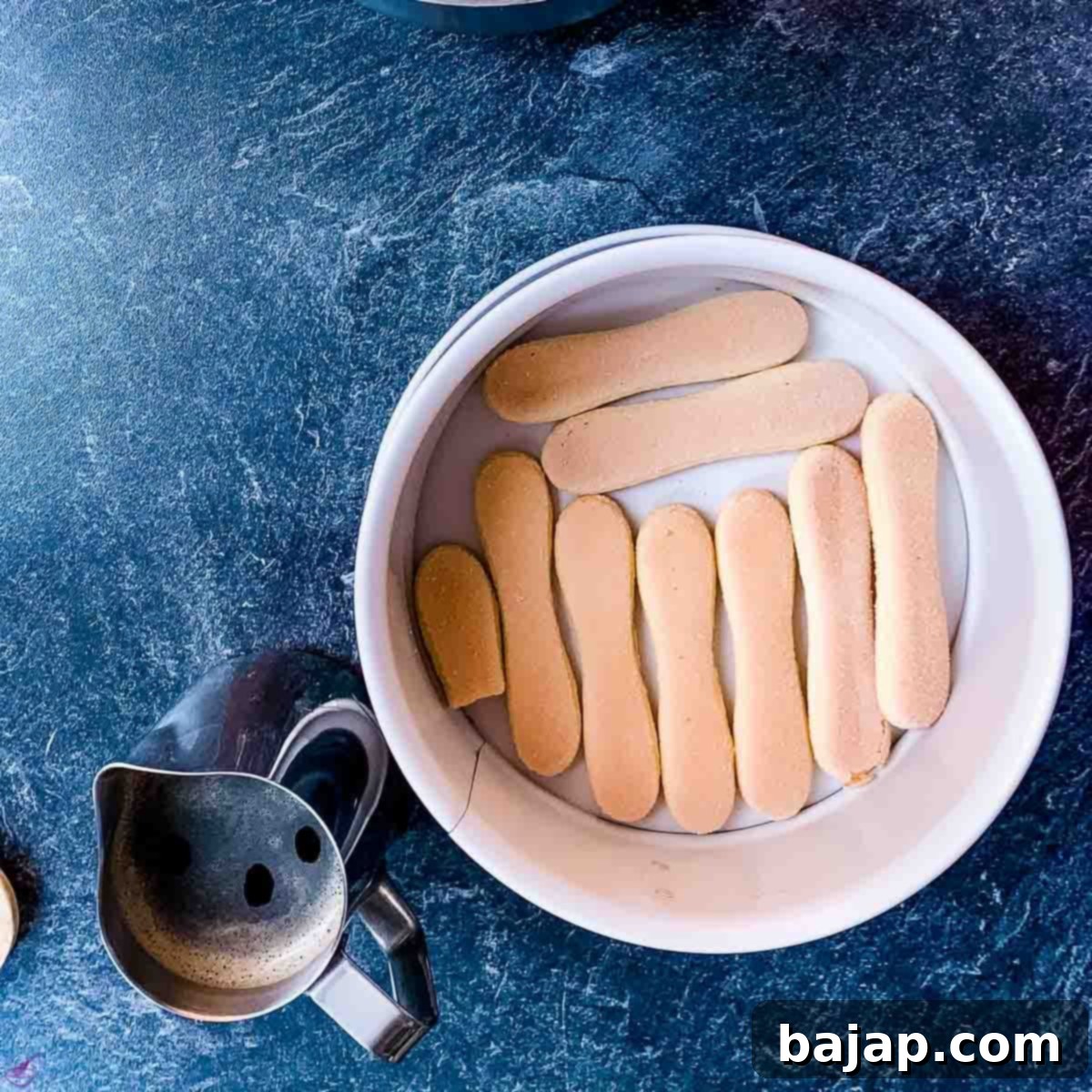 Place the ladyfingers close together as the bottom layer.
