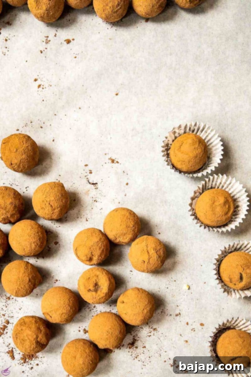 Finished salted caramel truffles with a liquid core, dusted in Criollo cocoa powder, presented elegantly.