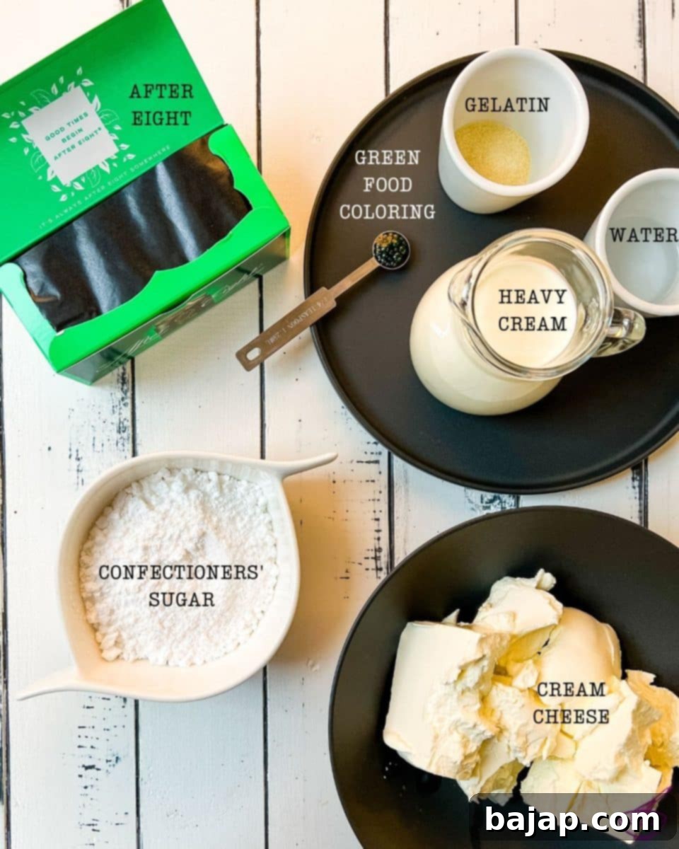 Ingredients for the vibrant green colored mint cream cheese filling, including cream cheese, confectioners' sugar, heavy cream, After Eight mints, vanilla extract, and green food coloring.