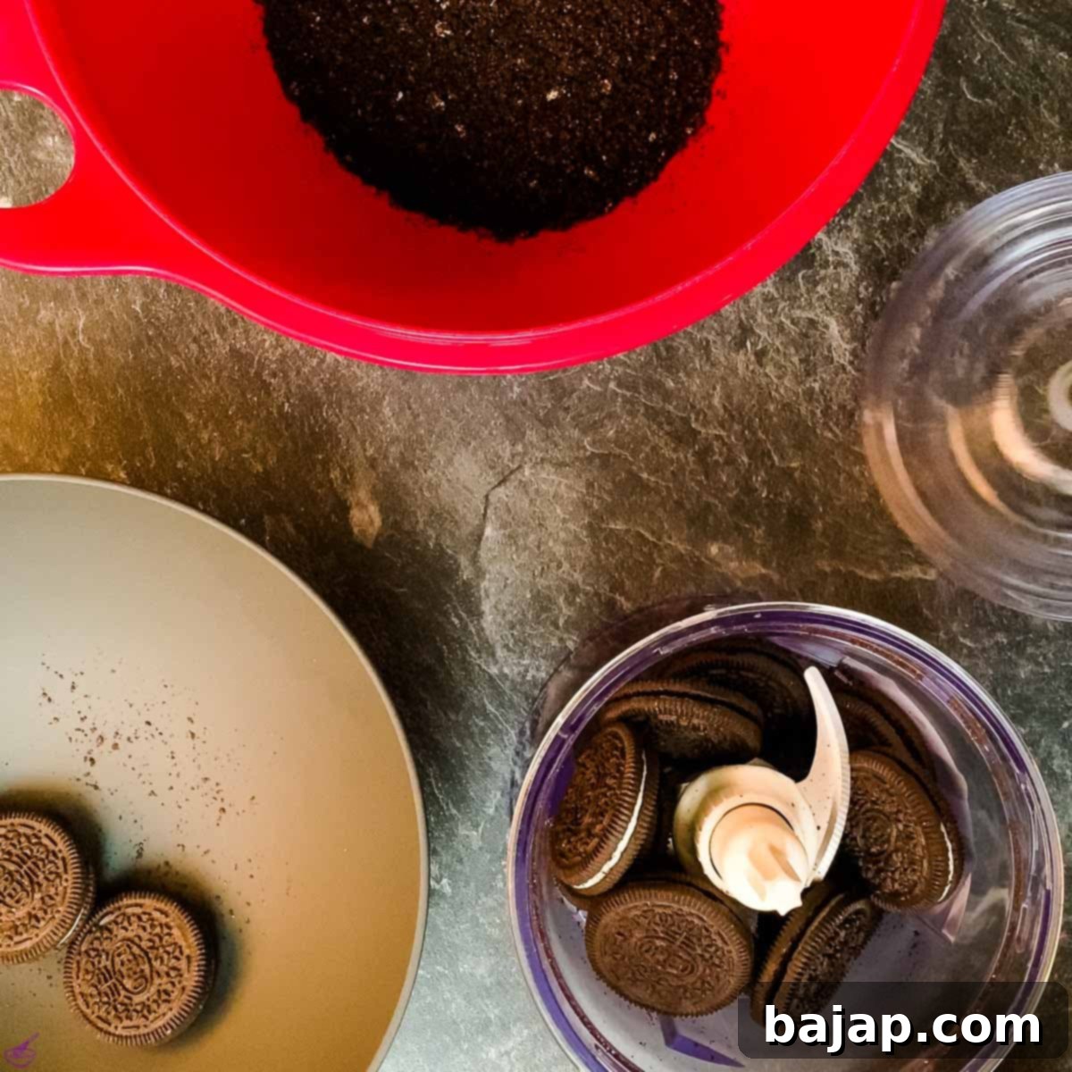 Crushed Oreo cookies in a food processor, ready to be combined with butter for the crust.