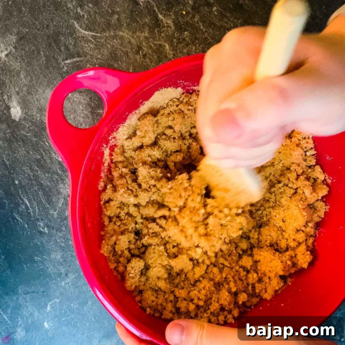 Combine the melted butter with the graham cracker crumbs and ground walnuts to create the cheesecake base mixture.