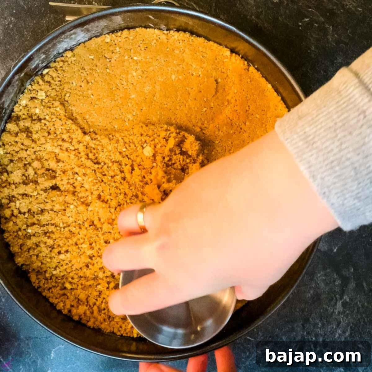 Press the walnut graham cracker crumbs firmly into the springform pan.