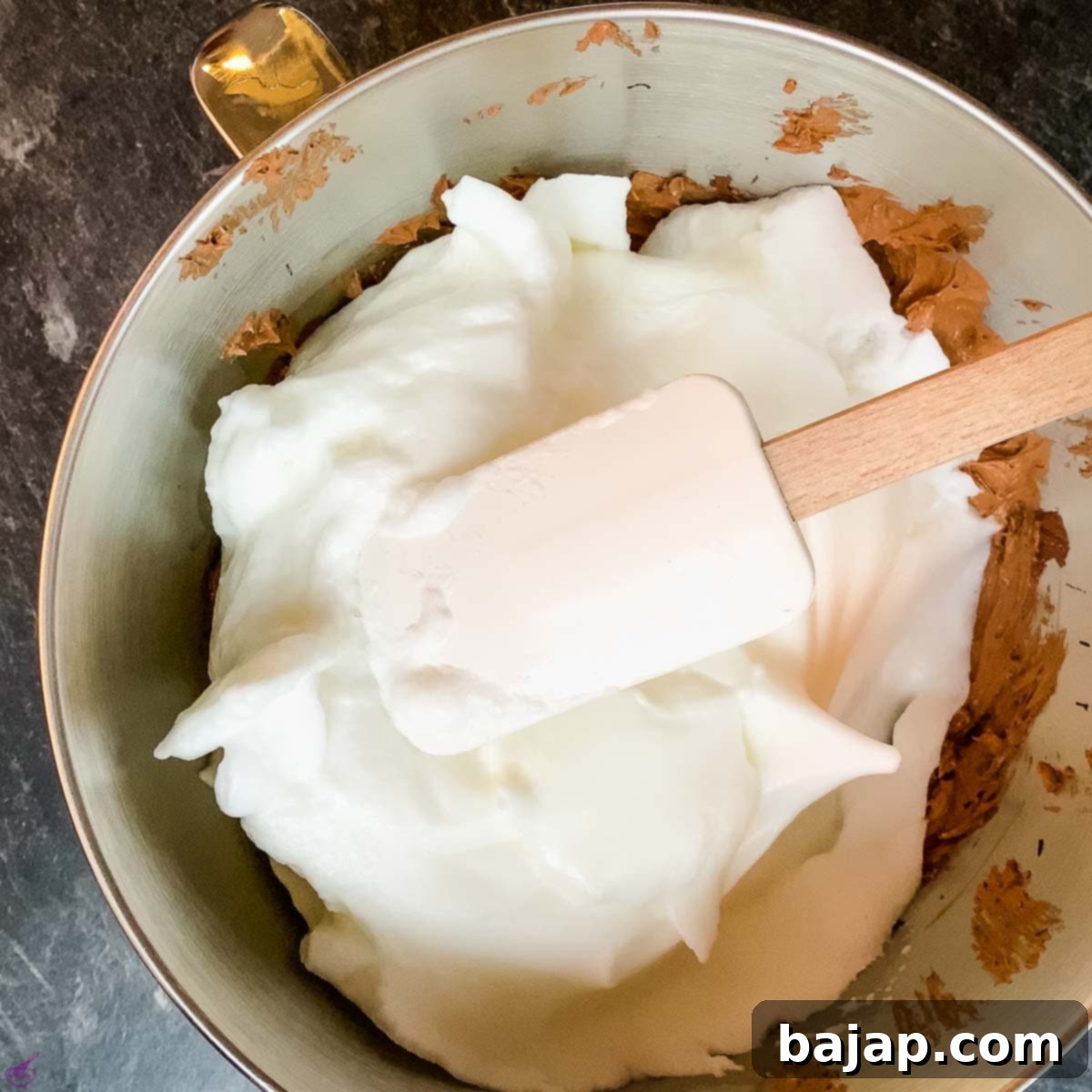 Gently fold the stiffly beaten egg whites into the chocolate batter.