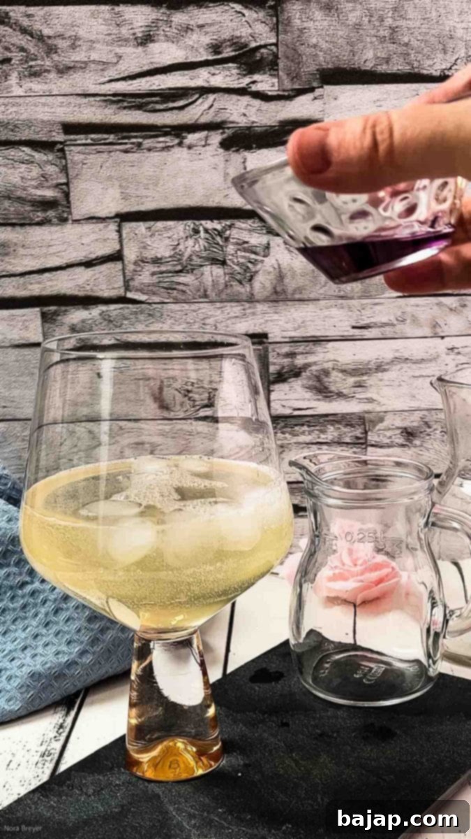 Adding lavender syrup to the cocktail.