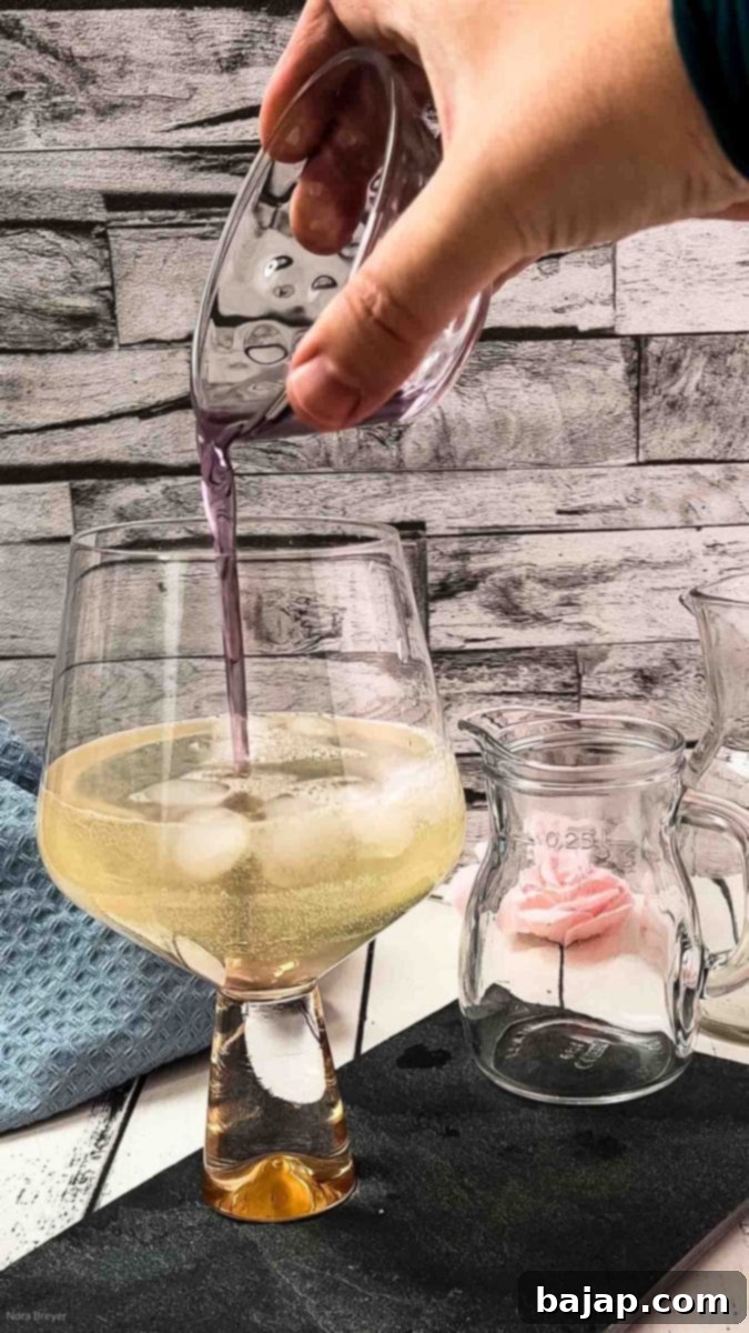 The finished lavender spritz cocktail, perfectly layered.