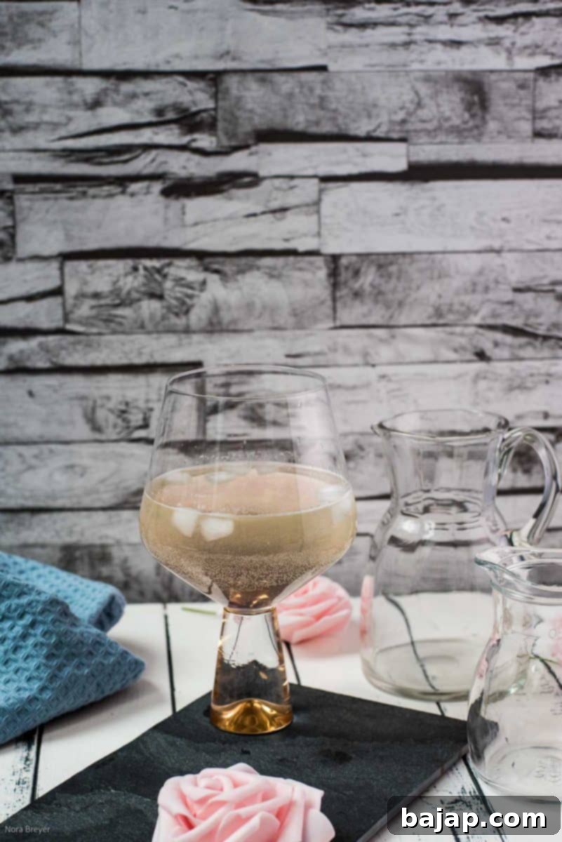 Refreshing lavender spritz cocktail with a slice of lemon and lavender sprig, ready to be enjoyed.