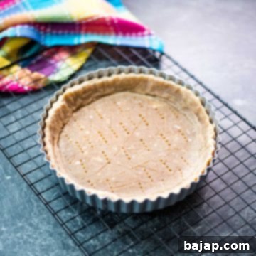 Tart Crust with Walnuts placed in tart form.