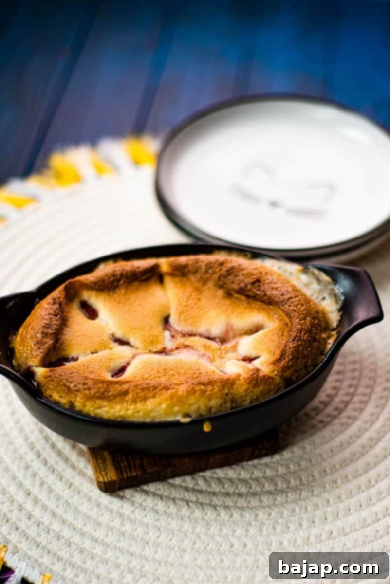 Delicious strawberry cobbler in black mini casserole pan.