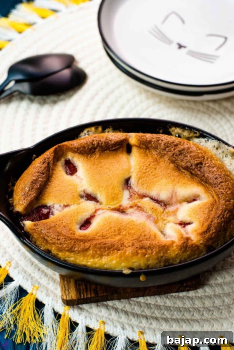 Delicious strawberry cobbler in black mini casserole pan.