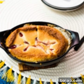 Delicious strawberry cobbler in black mini casserole pan.