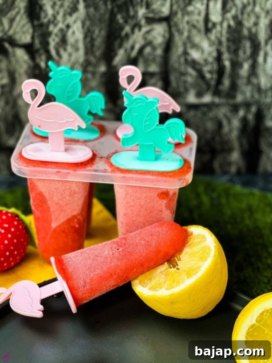 A popsicle mold filled with delicious strawberry ice and cute popsicle sticks inserted.