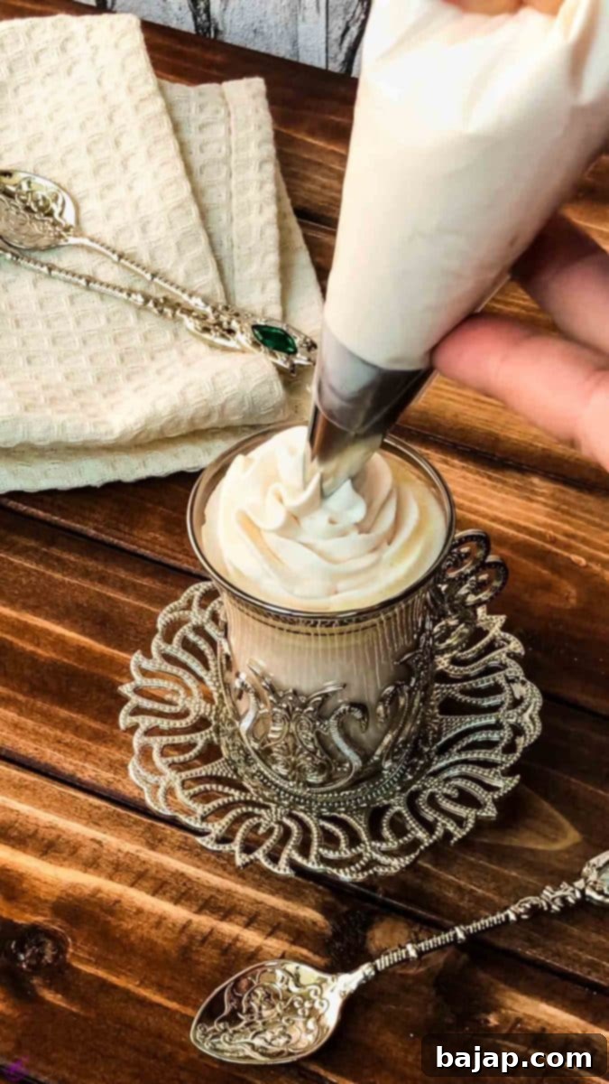 Piping a wonderful rosette of delicious strawberry flavored whipped cream on top of a cup of your favorite beverage.