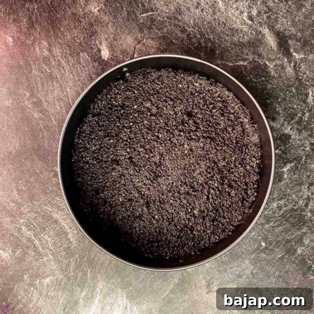 Fill the Oreo walnut crumbles into the prepared springform pan and press firmly.