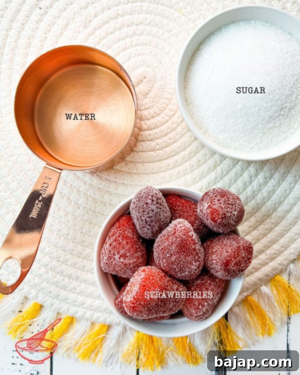 Three core ingredients: fresh strawberries, granulated sugar, and water are beautifully arranged on a dark surface, ready to create a delicious strawberry simple syrup.