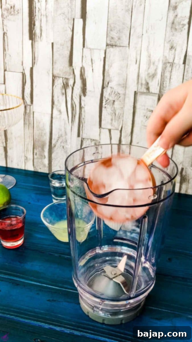 Fill the blenders' container with ice cubes for a frosty frozen strawberry daiquiri.
