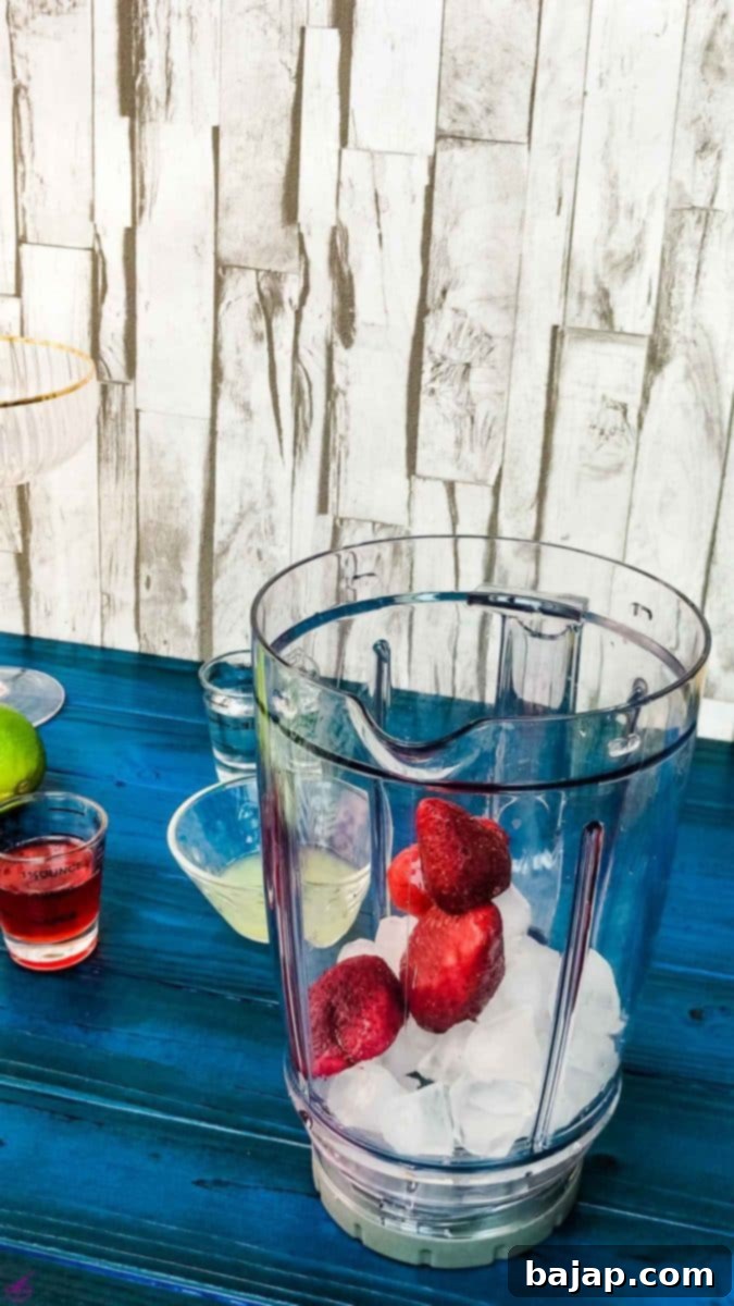 Add the fresh or frozen strawberries to the blenders' container for blending into a daiquiri.