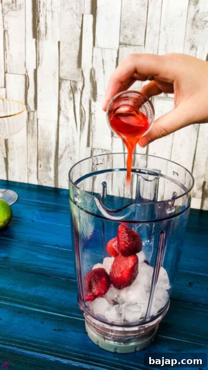 Add the homemade strawberry simple syrup to the blenders' container for a sweet frozen strawberry daiquiri.