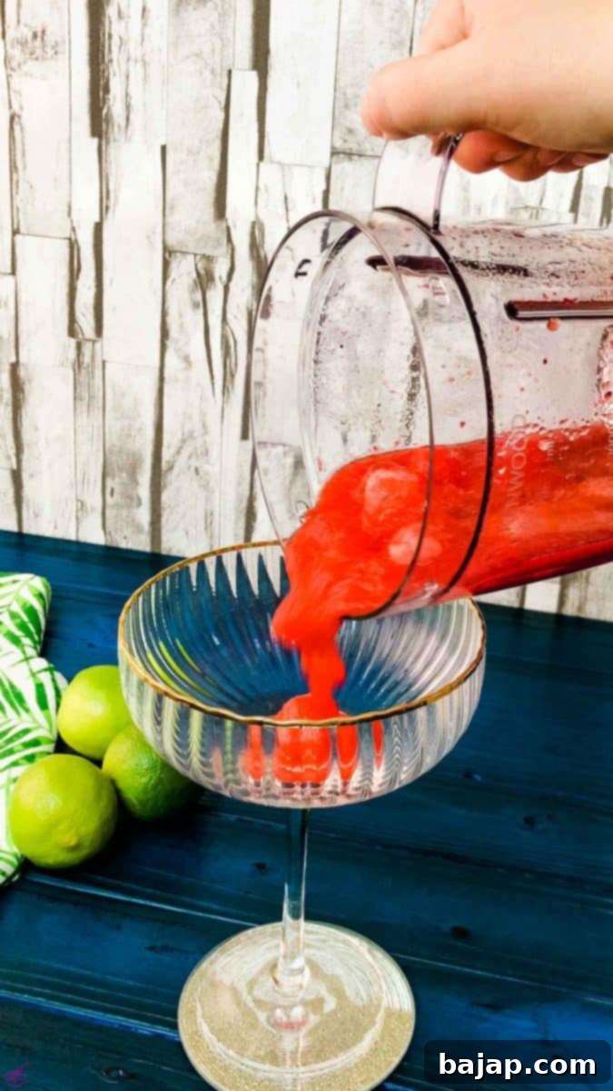 Pour the strawberry mixture into a cocktail glass for serving.