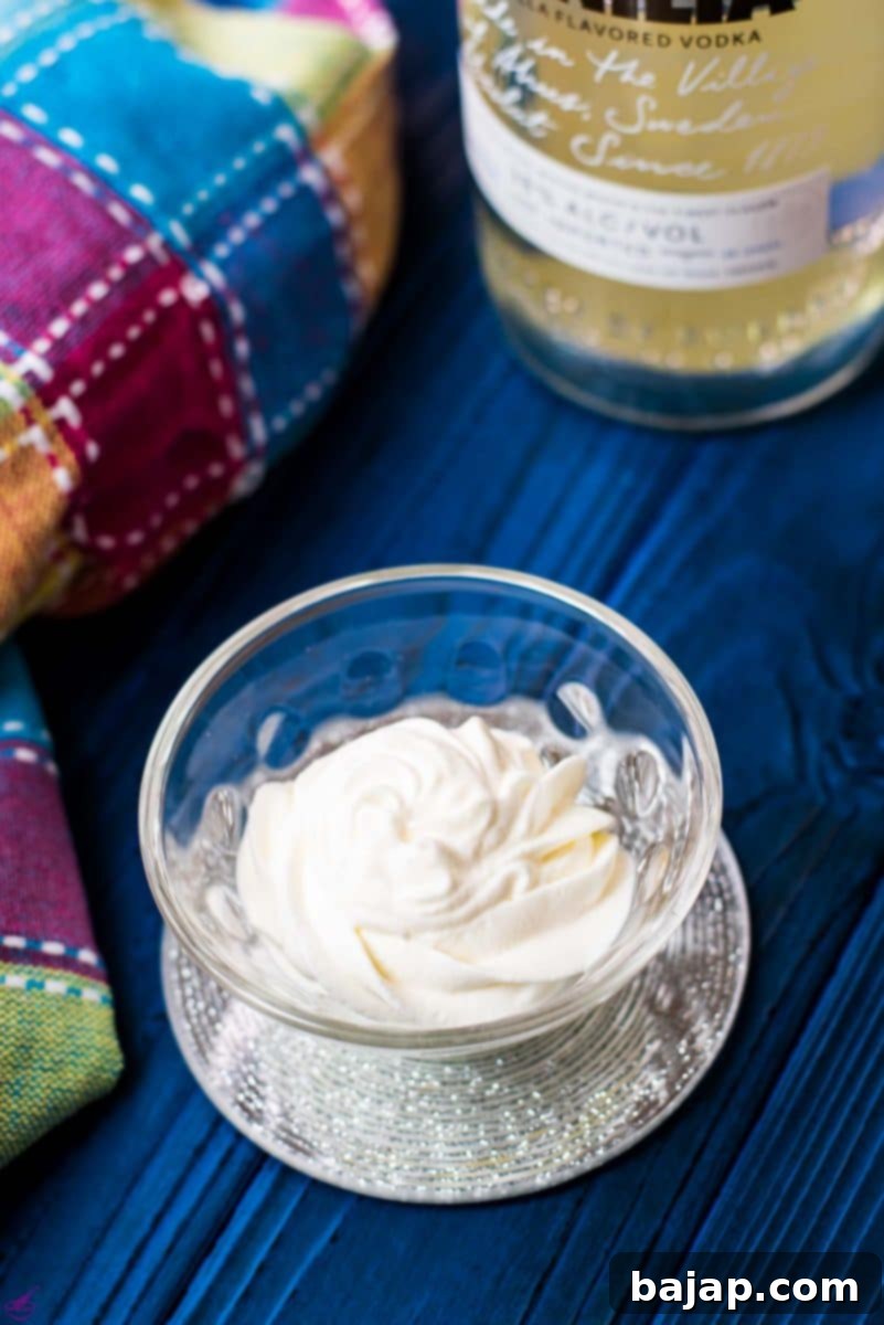 Beautifully piped rosette of whipped cream with vanilla vodka flavor, perfect for dessert toppings.