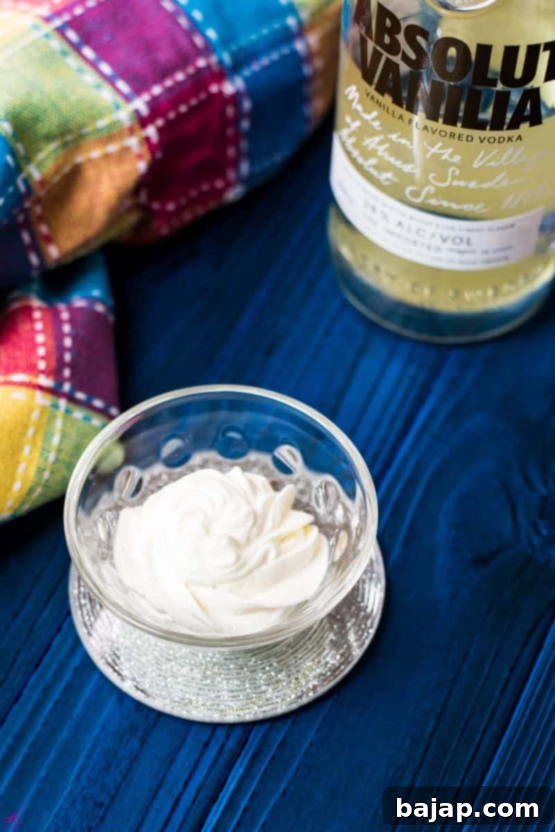 Beautifully piped rosette of vanilla vodka flavored whipped cream, showing perfect stiff peaks.