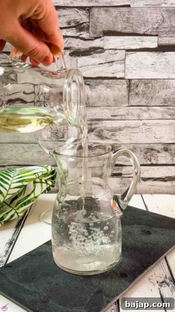 Add the light white wine to the club soda in the pitcher.