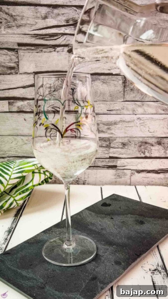 Empty the white wine club soda mixture into your drinking glass.