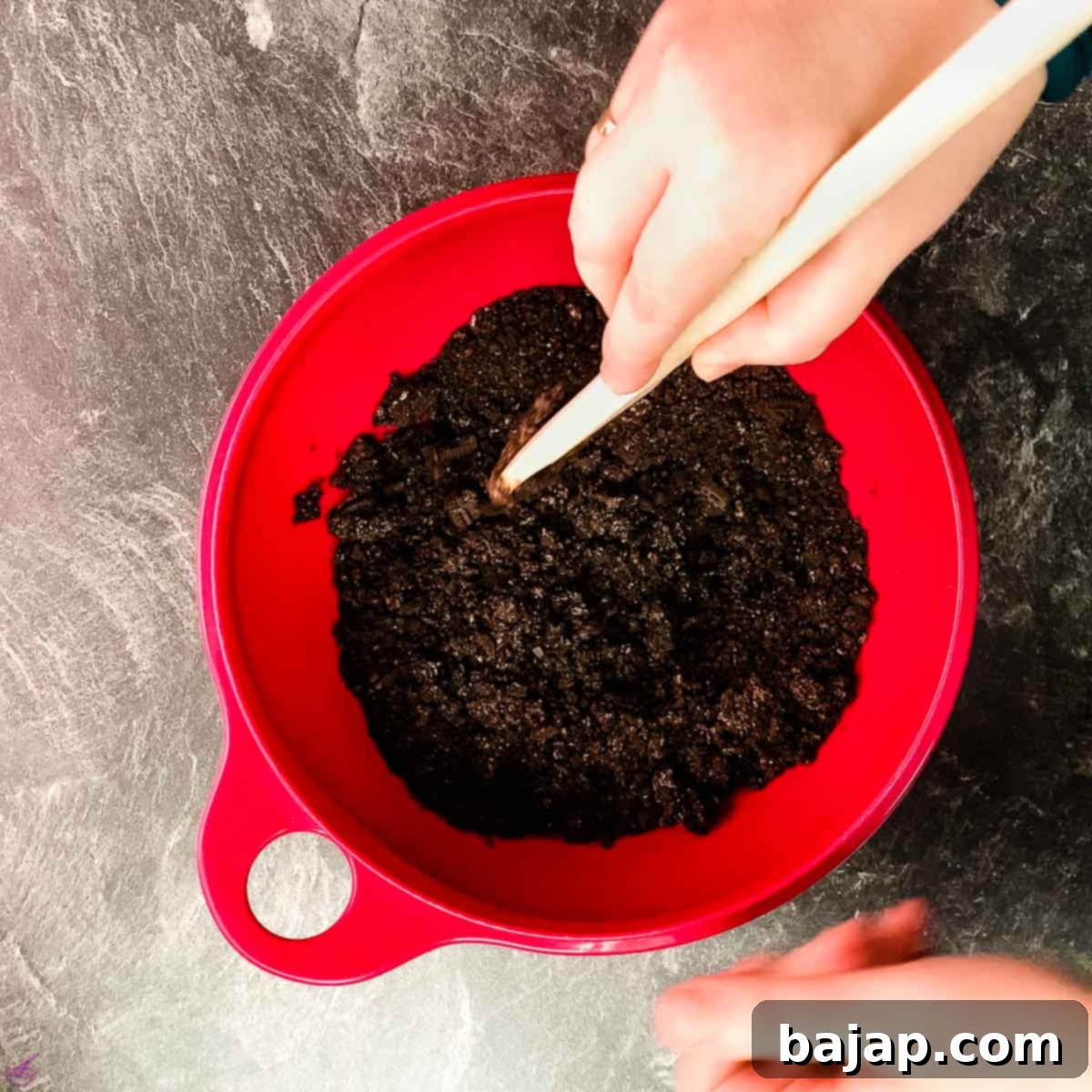 Combine the Oreo cookie crumbles with the melted butter.
