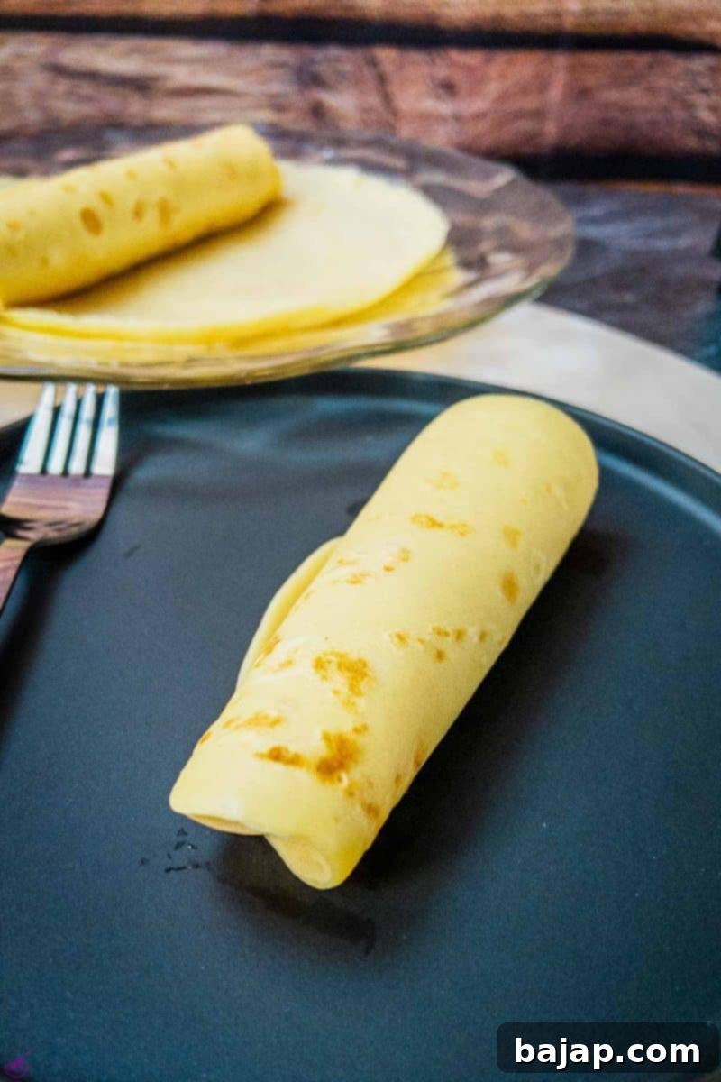 Form the jam-filled pancakes into a roll.