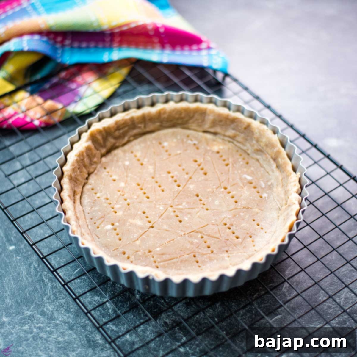 Tart Crust with Walnuts placed in tart form.