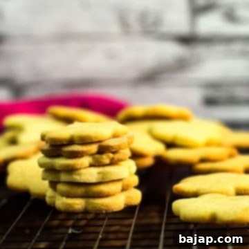 Gorgeous sugar cookies stacked beautifully on a cooling rack.