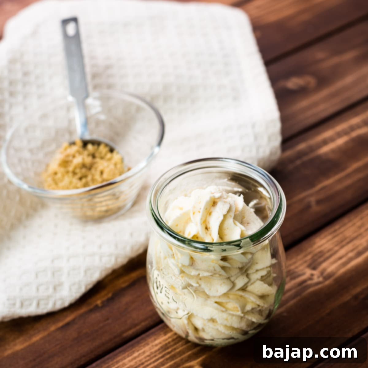 Almond whipped cream piped in a gorgeous Weck Jar on a wooden ground.