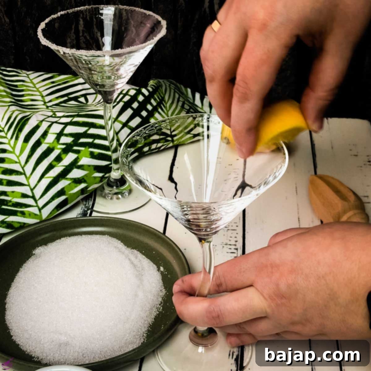 Swipe along the rim of the glass with the lemon wedge to moisten it for a sugar rim.