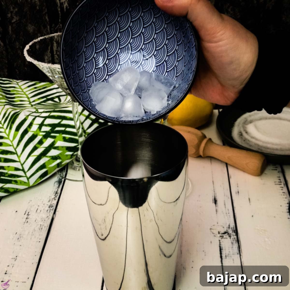 Add the ice cubes to the cocktail shaker.