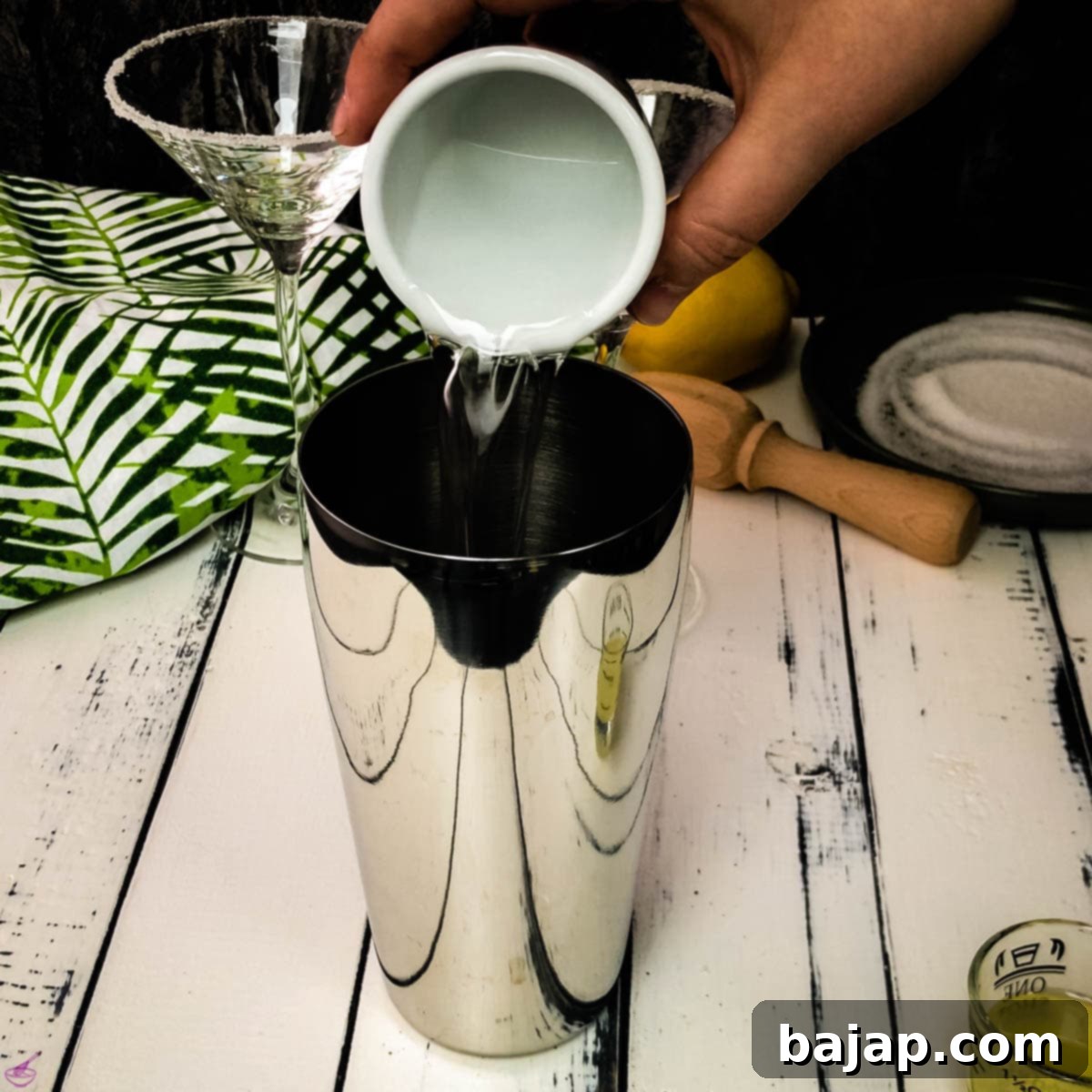 Pour the Cointreau orange liqueur into the cocktail shaker.