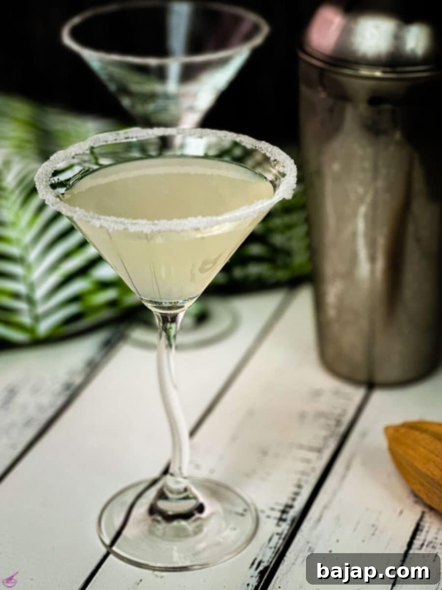 Gorgeous cocktail glass with a sugar rim filled with a delicious vodka sidecar.
