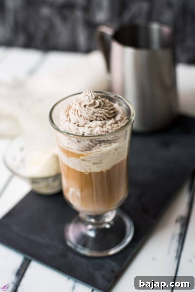 Beautiful glass filled with delicious vanilla iced coffee. Topped with chocolate-flavored whipped cream.
