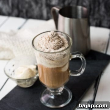 Beautiful glass filled with delicious vanilla iced coffee. Topped with chocolate-flavored whipped cream.