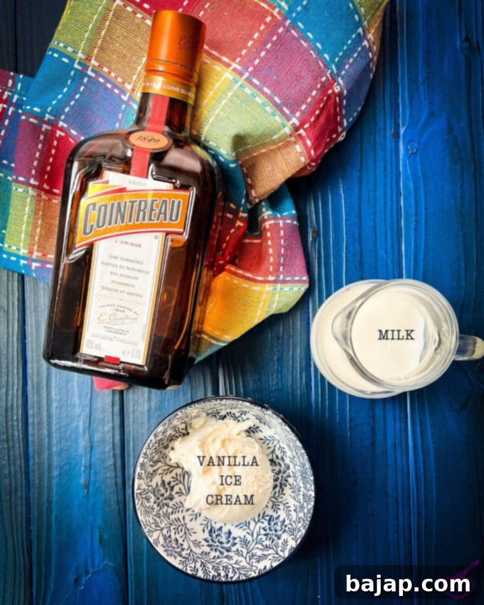 Three essential ingredients — whole milk, vanilla ice cream, and Cointreau — laid out for making a delicious boozy Cointreau milkshake.