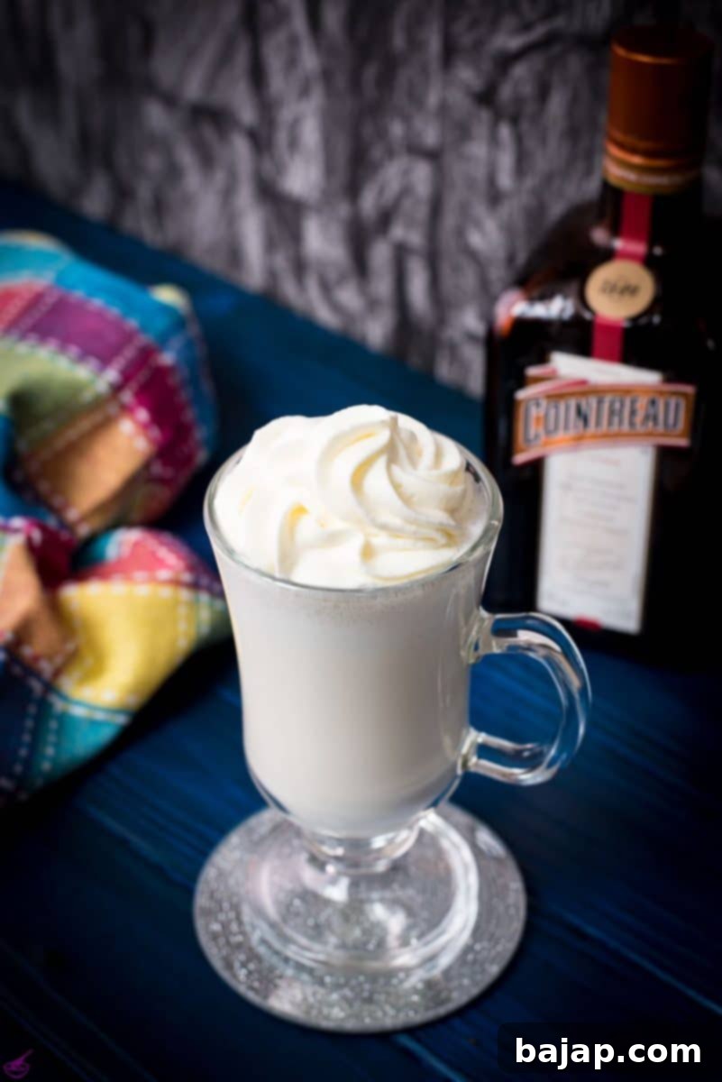 The essential tools for crafting a perfect Boozy Cointreau Milkshake: a blender for mixing, a serving glass for presentation, and measuring tools for precision.