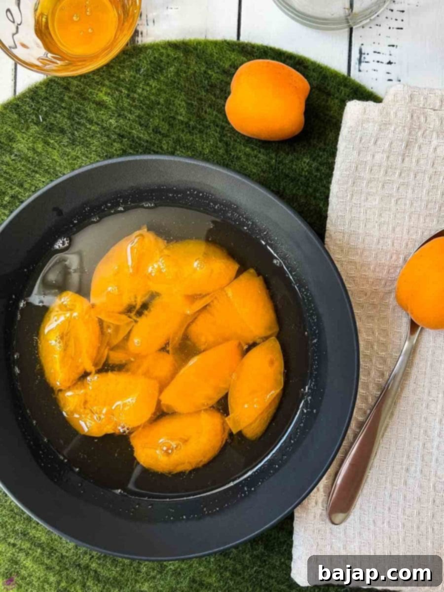 Black bowl filled with a healthy and delicious apricot compote.