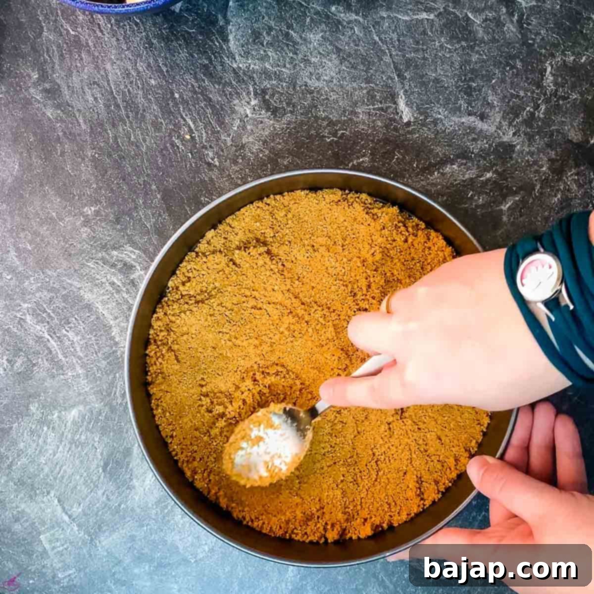 Press the butter graham cracker crumbs evenly into the springform pan.