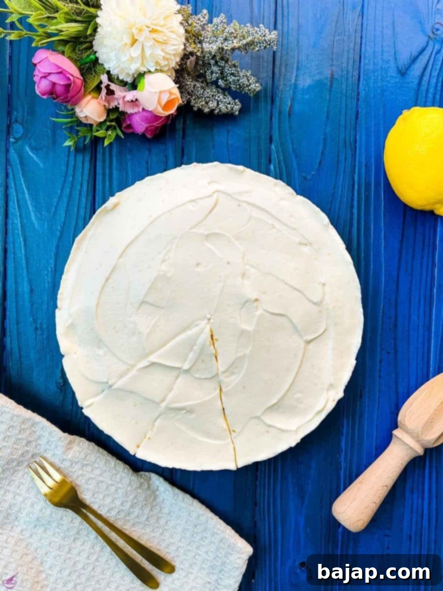 Refreshing lemon cheesecake on dark blue wooden background.