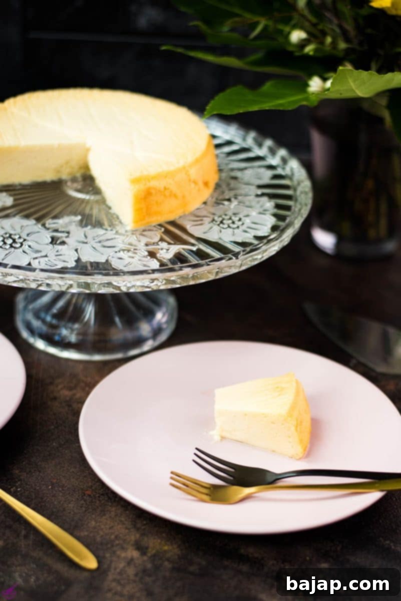 Freshly baked three ingredient yogurt cake on gorgeous glass cake plate, cooling down before serving.