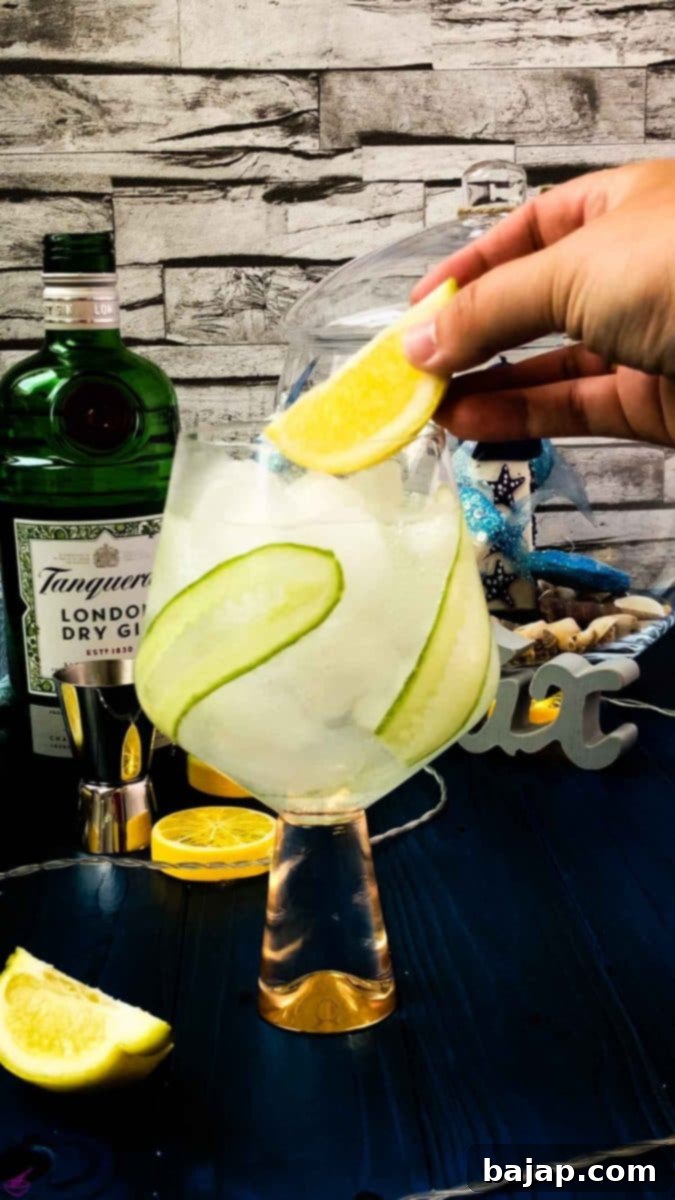 Add a lemon wedge on top of your cucumber gin and tonic.