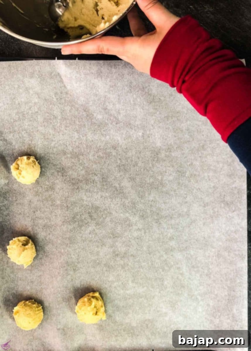 Scoop the cookies onto the prepped baking tray.